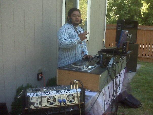 DJ Sio spinning at an outdoor backyard party