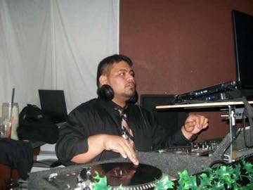 DJ Sio at the decks during an indoor set